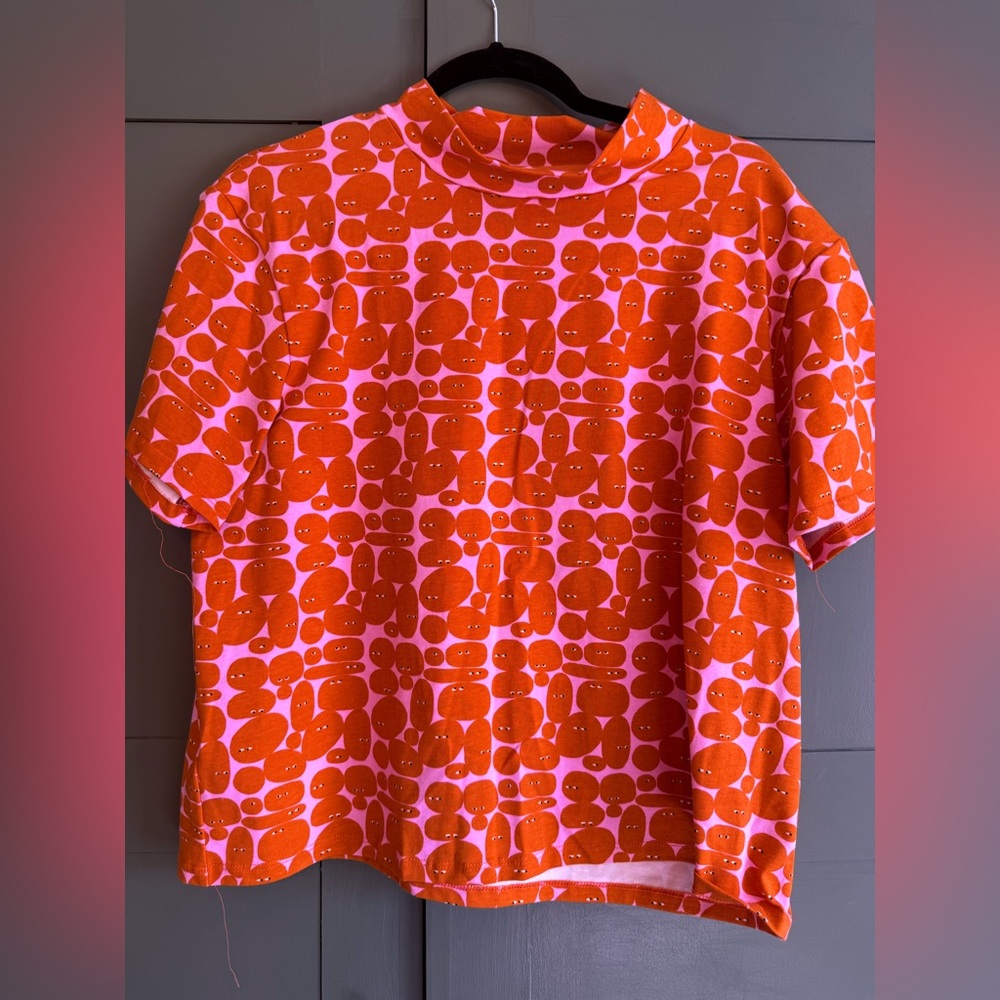 Nooworks Bold Orange Faces on Pink Tee
